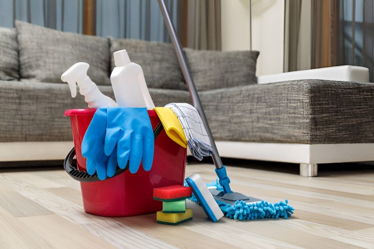 cleaning tools and a bucket of cleaning solutions on vinyl plank flooring