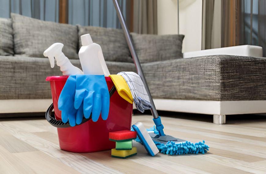cleaning tools and a bucket of cleaning solutions on vinyl plank flooring